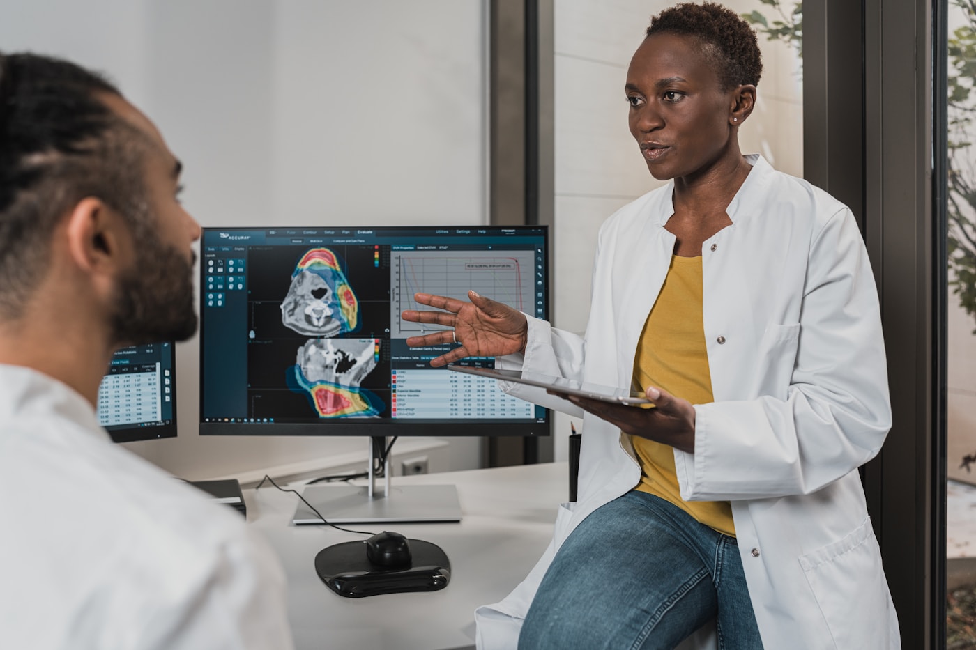 Woman clinician reviewing diagnostic imaging on a monitor