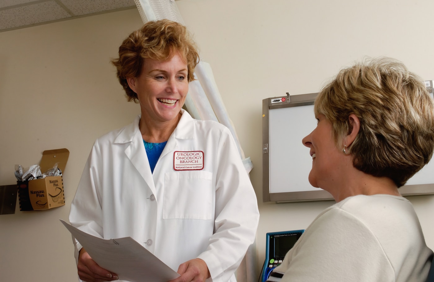 Woman physician speaking with a patient during a consultation
